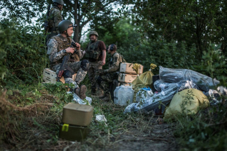 Ukrainian service members rest among trees, as Russia's attack on Ukraine continues, outside the city of Sievierodonetsk, Ukraine June 19, 2022. Picture taken June 19, 2022. 