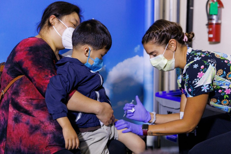 Following CDC approval for vaccination of children aged 6 months to 5 years, 3 year-old Jake Guojo sits on his mother's lap, as nurse Jillian Mercer administers the Moderna vaccine for the coronavirus disease (COVID-19) at Rady Childrenâs Hospital in Sa