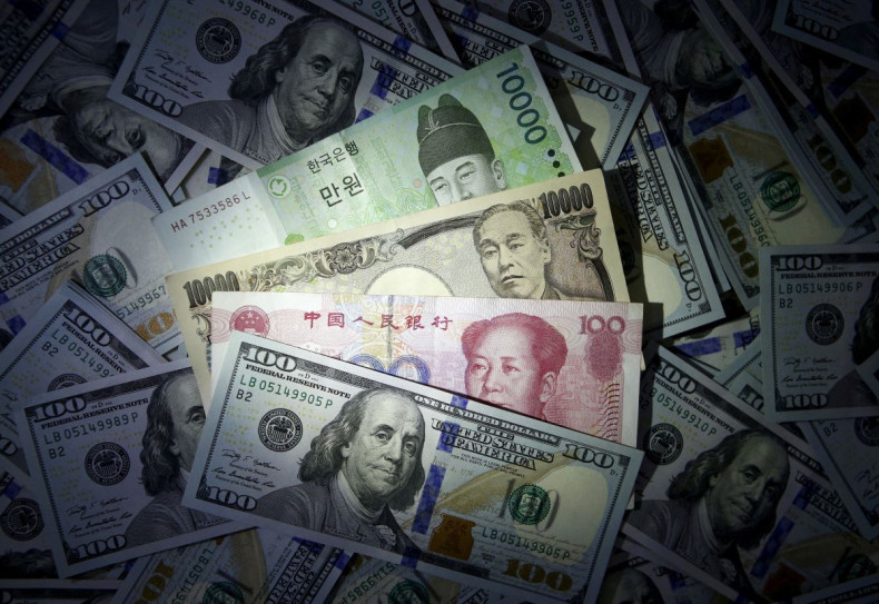 South Korean won, Chinese yuan and Japanese yen notes are seen on U.S. $100 notes in this file photo illustration shot December 15, 2015. 