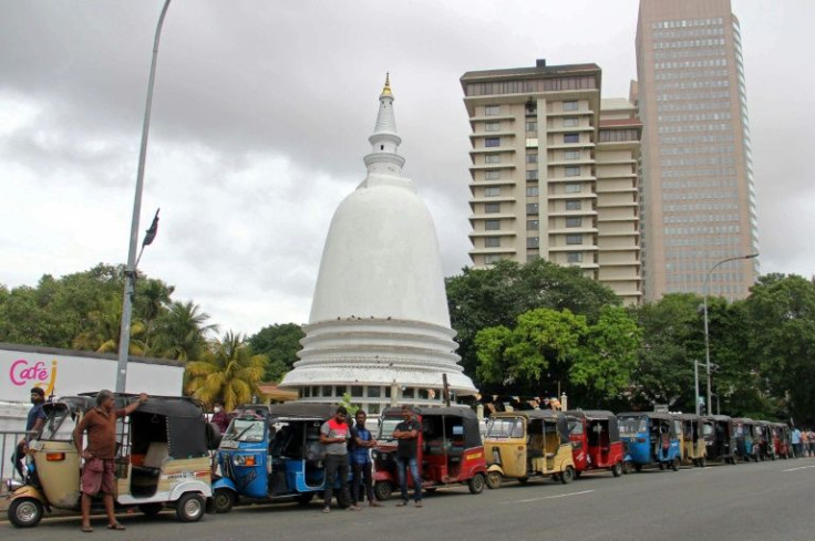 Motorists queue to buy scarce petrol in Colombo earlier this month as Sri Lanka grapples with shortages of essential goods