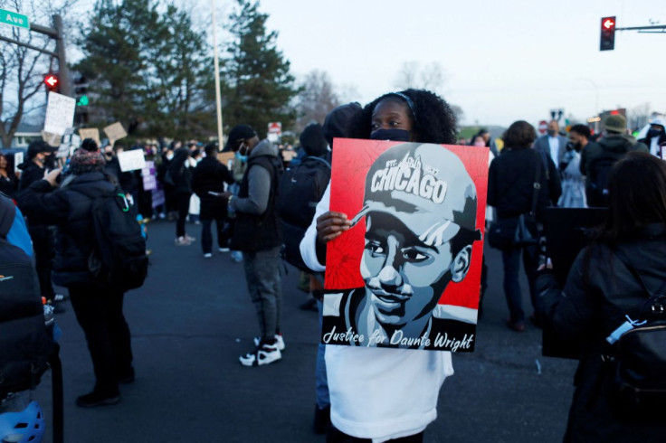 A protester holds up a poster depicting Daunte Wright, as protests continue after former police officer Kim Potter fatally shot Daunte Wright, in Brooklyn Center, Minnesota, U.S. April 16, 2021.