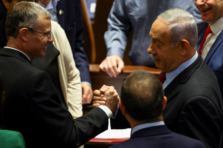 Former Israeli Prime Minister Benjamin Netanyahu is surrounded by Likud party members as he attends a preliminary reading at the Israeli parliament, the Knesset, of a bill to dissolve the parliament after Prime Minister Naftali Bennett and Foreign Ministe