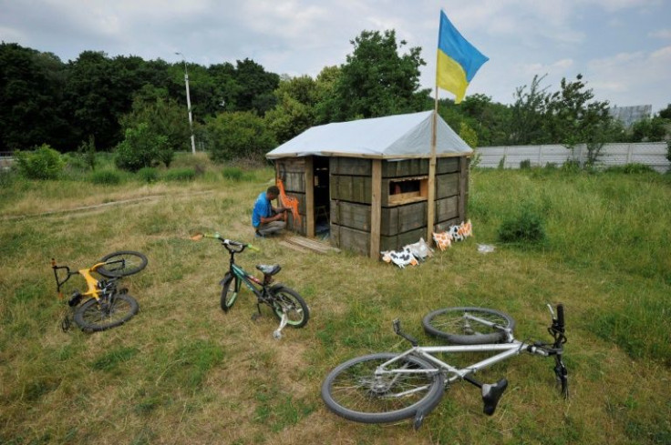 A man decorates a toy cabin for children made of used ammunition crates in the northern village of Novoselivka, near the city of Chernigiv, which saw fierce fighting in the early days of the war