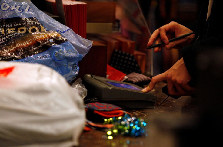 A customer signs the credit card pad as he pays for a purchase at Macy's in New York November 26, 2010.  