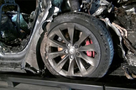 The remains of a Tesla vehicle are seen after it crashed in The Woodlands, Texas, April 17, 2021, in this still image from video obtained via social media. Video taken April 17, 2021. SCOTT J. ENGLE via 