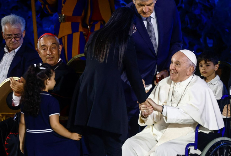 Zakia Seddiki, widow of slain Italian Ambassador Luca Attanasio, with daughters greets Pope Francis during the 10th World Meeting of Families at the Vatican, June 22, 2022.