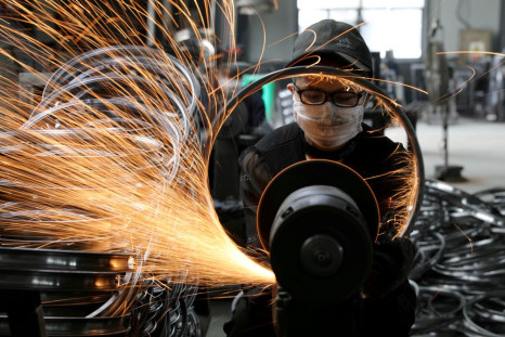 A worker polishes a bicycle steel rim at a factory manufacturing sports equipment in Hangzhou, Zhejiang province, China September 2, 2019. China Daily via REUTERS 