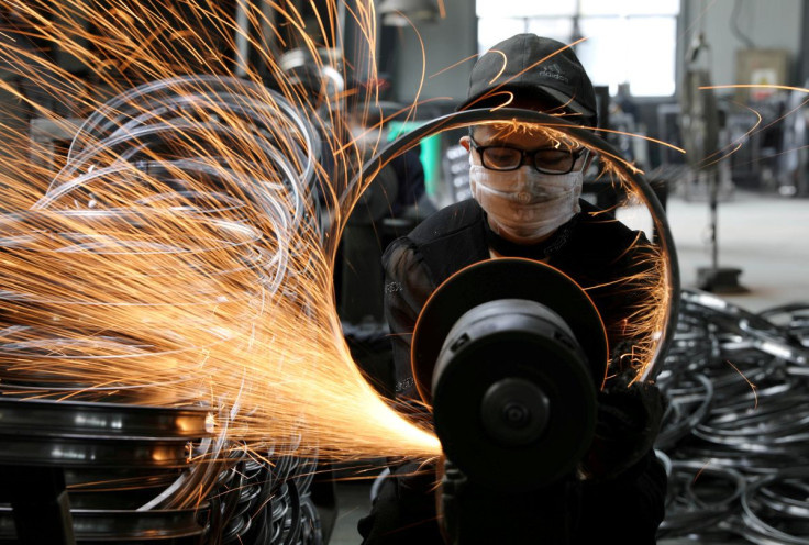 A worker polishes a bicycle steel rim at a factory manufacturing sports equipment in Hangzhou, Zhejiang province, China September 2, 2019. China Daily via REUTERS 