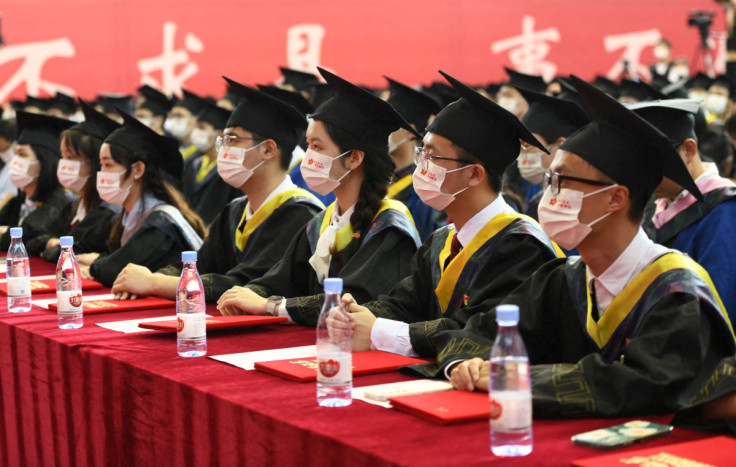 Graduating students wearing face masks attend a commencement ceremony at Chongqing University of Posts and Telecommunications in Chongqing, China June 22, 2022. Cnsphoto via REUTERS