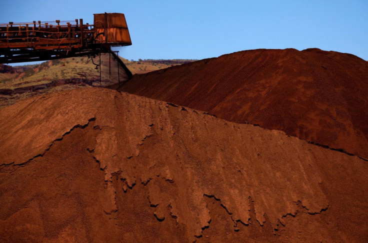 A stacker unloads iron ore onto a pile at a mine located in the Pilbara region of Western Australia December 2, 2013.