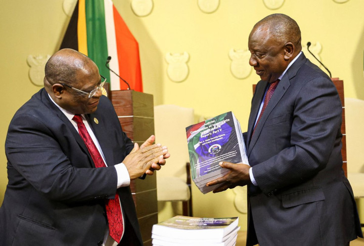 South Africa's President Cyril Ramaphosa receives the final investigation report from Chief Justice Raymond Zondo at the government's Union Buildings in Pretoria, South Africa, June 22, 2022.