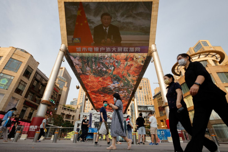 A screen shows a CCTV state media news broadcast of Chinese President Xi Jinping, addressing the BRICS Business Forum via video link, at a shopping center in Beijing, China, June 23, 2022.  