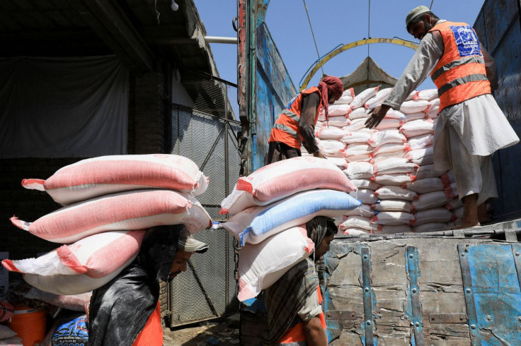 Volunteers from the Al-Khidmat Foundation load sacks of flour on a truck for the people affected by the earthquake in Afghanistan, in Peshawar, Pakistan June 23, 2022.