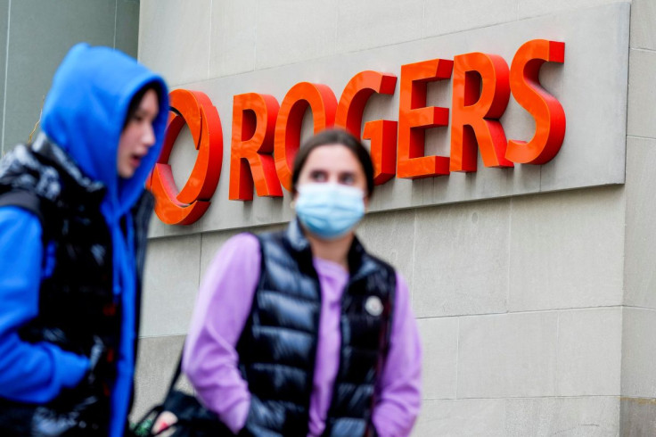 People walk in front of the the Rogers Building, quarters of Rogers Communications in Toronto, Ontario, Canada October 22, 2021.   