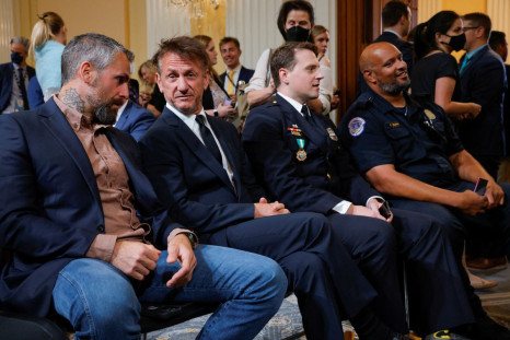 Actor Sean Penn sits with former Washington police officer Michael Fanone, Metropolitan police officer Daniel Hodges and Metropolitan police officer Harry Dunn, all of whom were assaulted during the January 6, 2021 attack on the U.S. Capitol, during the f