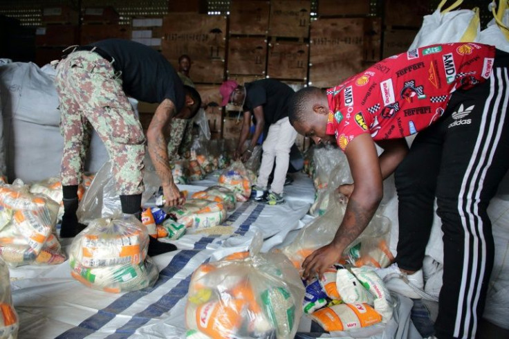 Soldiers pack food, part of 40,000 tons of goods donated by Venezuela, after heavy rainfall caused severe floods in Paramaribo, Suriname, on June 18, 2022