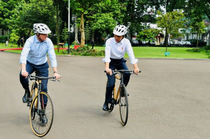 Indonesian President Joko Widodo (R) presented new Australian Prime Minister Anthony Albanese with a bamboo bike