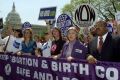 National Organization for Women president Patricia Ireland (C) marches with pro-choice supporters past the U.S. Capitol Building in Washington April 22, 2001./File Photo