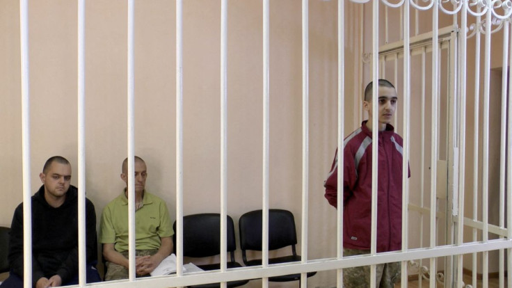 A still image, taken from footage of the Supreme Court of the self-proclaimed Donetsk People's Republic, shows Britons Aiden Aslin, Shaun Pinner and Moroccan Brahim Saadoun captured by Russian forces during a military conflict in Ukraine, in a courtroom c