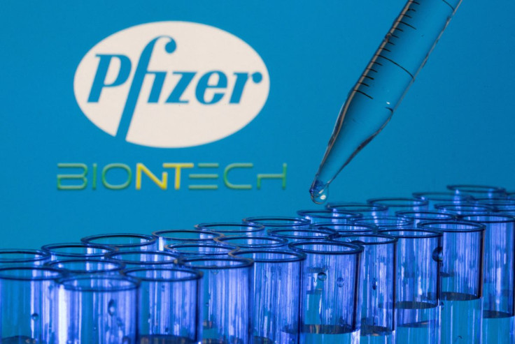 Test tubes are seen in front of displayed Pfizer and Biontech logos in this illustration taken, May 21, 2021. 