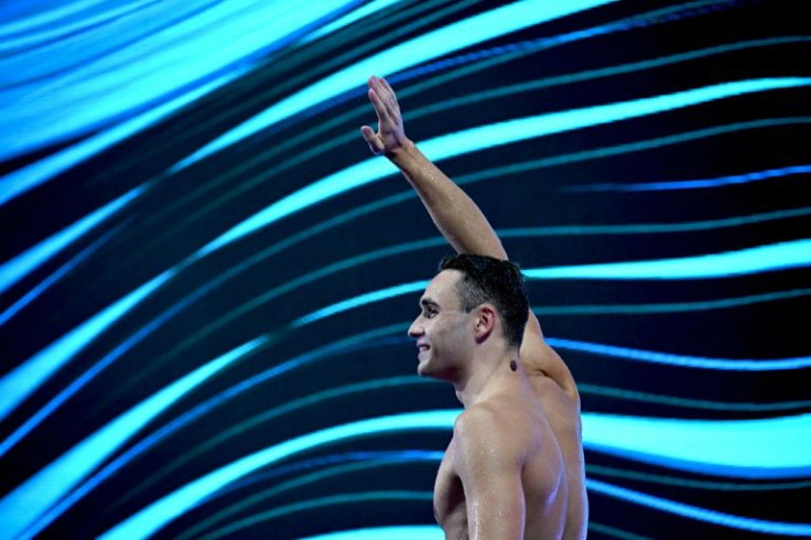 Kristof Milak waves after taking gold in the men's 100m butterfly final