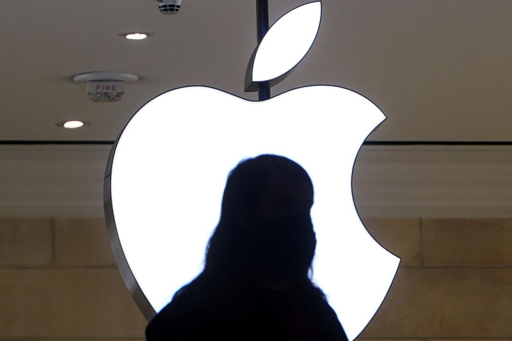 A person is silhouetted against a logo sign of the Apple Store in the Grand Central Terminal in the Manhattan borough of New York City, New York, U.S., January 4, 2022.  
