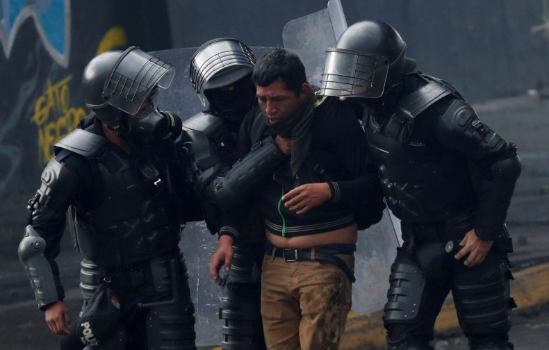 A demonstrator is detained by police officers during an anti-government protest amid a stalemate between the government of President Guillermo Lasso and largely indigenous demonstrators who demand an end to emergency measures, in Quito, Ecuador June 24, 2