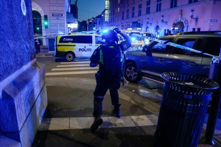 Police secure the area following a shooting in central Oslo that killed two people