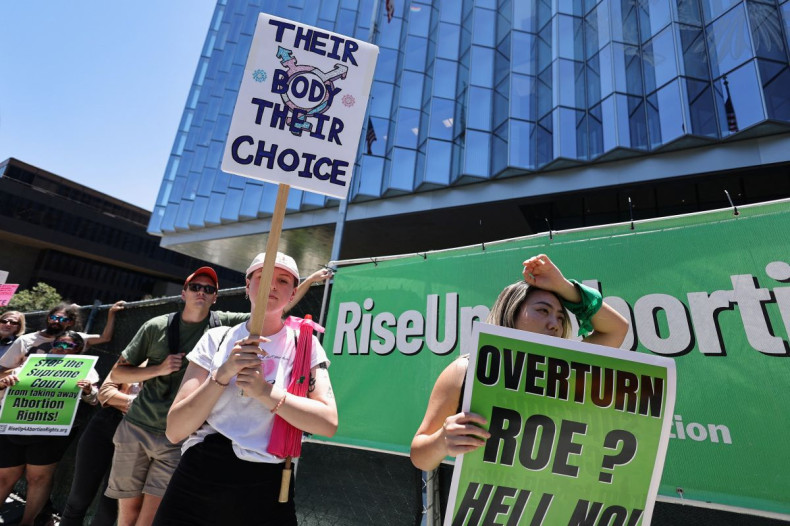 Abortion rights protesters hold signs as they demonstrate after the U.S. Supreme Court ruled in the Dobbs v Womenâs Health Organization abortion case, overturning the landmark Roe v Wade abortion decision in Los Angeles, California, U.S., June 24, 2022.