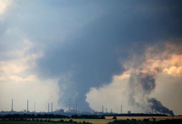 Smoke billows over the oil refinery outside of Lysychansk, one of two key cities where Russia is advancing towards