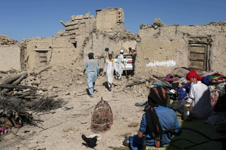 Afghan men try to retrieve a car from the debris of damaged houses after the recent earthquake in Wor Kali village in the Barmal district of Paktika province, Afghanistan, June 25, 2022. 