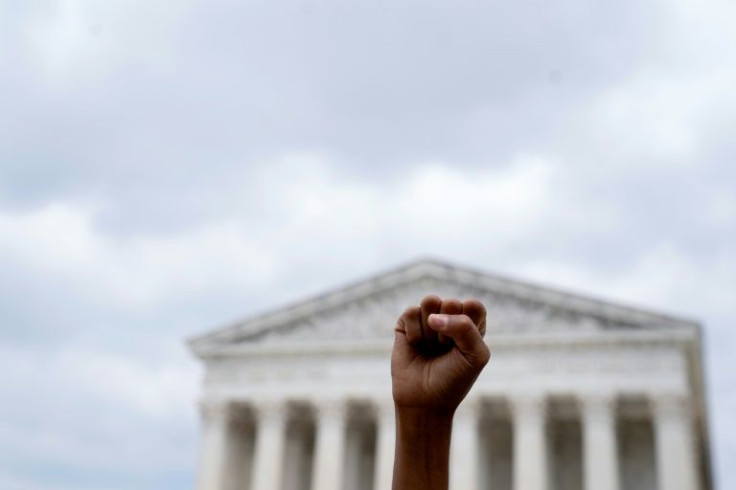An abortion rights activist raises their fist outside the US Supreme Court