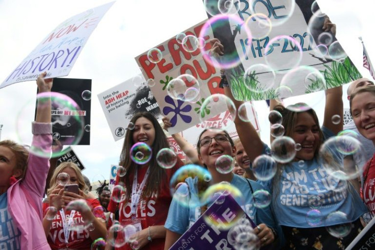 Anti-abortion campaigners celebrate outside the US Supreme Court in Washington, DC, on June 24, 2022, after it announced that it had overturned Roe v Wade