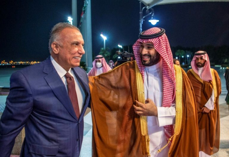 Saudi Crown Prince Mohammed bin Salman (R) receives Iraqi Prime Minister Mustafa al-Kadhemi at the airport in the Red Sea city of Jeddah