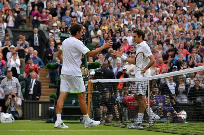 That was then: Sergiy Stakhovsky (left) shakes hands at the net with Roger Federer after his 2013 win at Wimbledon