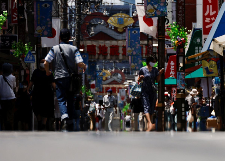 Passersby are seen through a heat haze during hot weather at Sugamo district in Tokyo, Japan June 27, 2022.