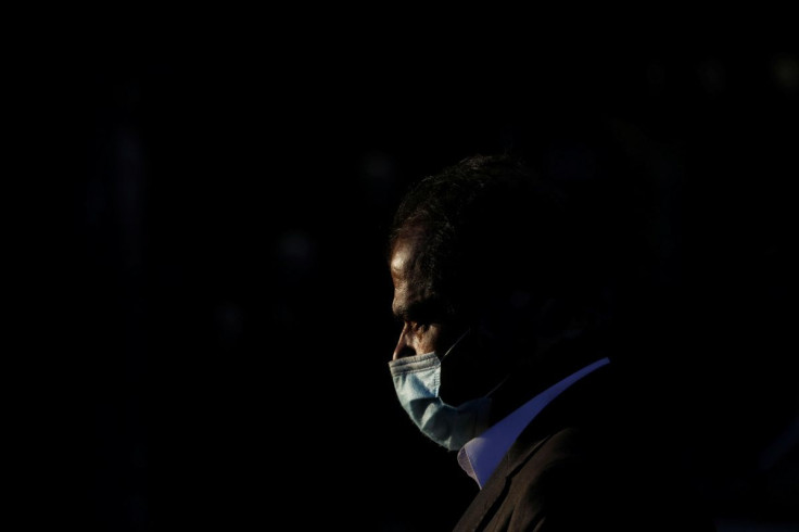 A man wears protective mask to prevent the spread of the coronavirus disease (COVID-19) while he walks along a road in Karachi, Pakistan January 12, 2021. 