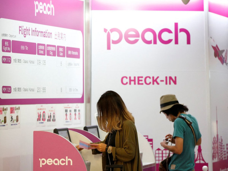Passengers use Peach Aviation's check-in machines at New Tokyo international airport in Narita, east of Tokyo, July 7, 2014.