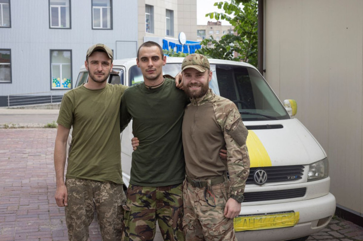 Anton (R), a soldier who returned from Sievierodonetsk, poses for a picture with his friends, amid Russia's invasion of the country, in Slovyansk, Donetsk region, Ukraine, June 26, 2022.