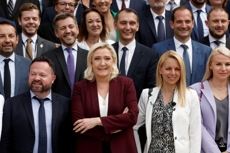 Marine Le Pen, French far-right National Rally (Rassemblement National) party leader and member of parliament, poses for a family photo with newly-elected lawmakers from the National Rally party at the National Assembly in Paris, France, France, June 22,