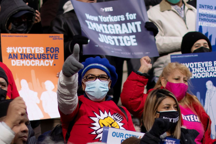 People take part in a rally 'Victory Rally' to allow non-citizen NYC residents to vote in local elections, at the steeps of the New York City Hall, in New York, U.S., December 9, 2021. 