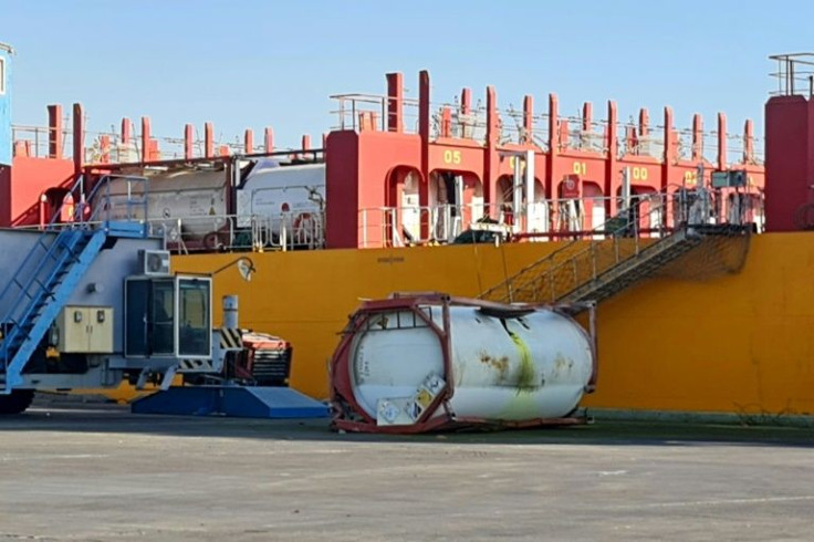 The fallen white tank, punctured and stained yellow from where the gas poured out, came to rest on the dock directly beside the Forest 6 vessel