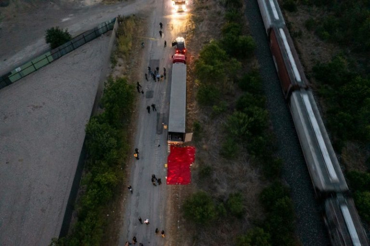 Law enforcement investigate a tractor-trailer in San Antonio, Texas where at least 46 migrants were found dead on June 27, 2022