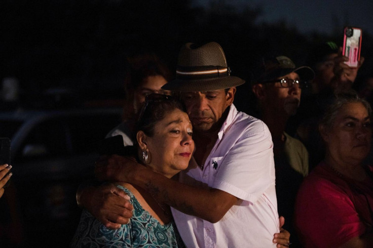 Christine and Michael Ybarra embrace at the scene where people were found dead inside a trailer truck in San Antonio, Texas, U.S. June 27, 2022. 