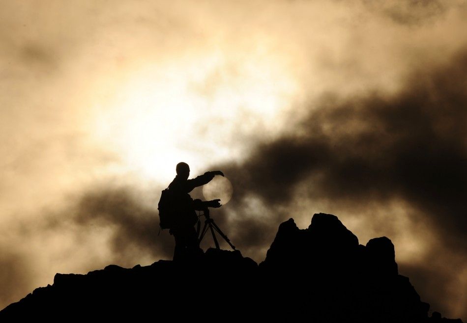 A man uses a camera on a rocky crest filled with astronomical markers during the summer solstice at the Kokino megalithic observatory June 21, 2010. The 3,800-year-old observatory was discovered in 2001 in the northwestern town of Kumanovo, 70 km 43 mile