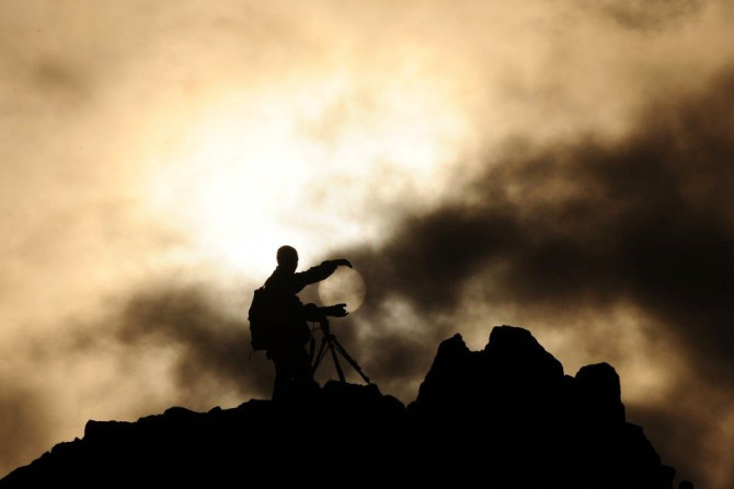 A man uses a camera on a rocky crest filled with astronomical markers during the summer solstice at the Kokino megalithic observatory June 21, 2010. The 3,800-year-old observatory was discovered in 2001 in the northwestern town of Kumanovo, 70 km (43 mile