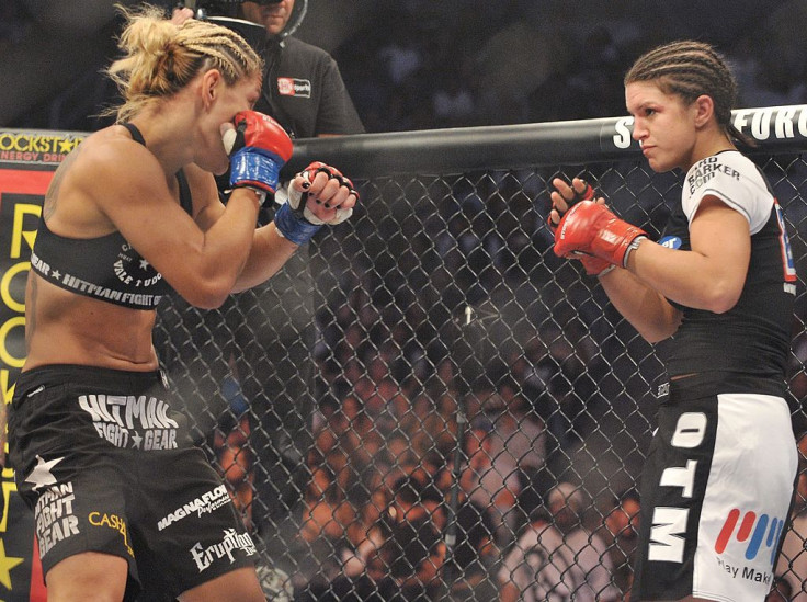 Cris Cyborg (L) battles Gina Carano