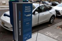 A electric vehicle charger is seen as a vehicle charges in Manhattan, New York, U.S., December 7, 2021. 