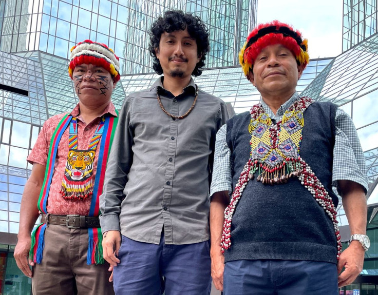 Ankuash Mitiap Kapuchak and Shapiom Noningo Sesen, indigenous leaders from Peru and Ricardo Perez of the environmental activist group Amazon Watch pose in front of Deutsche Bank headquarters in Frankfurt, Germany, June 27, 2022. Picture taken June 27, 202