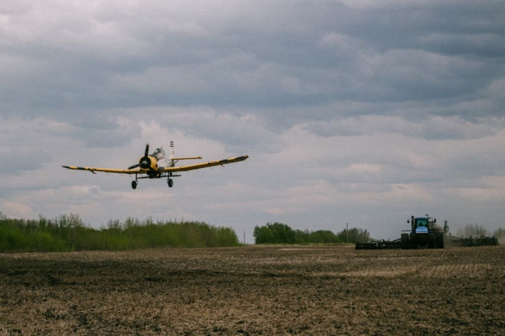 John Lepp seeds wet spots in a field with canola by airplane, while daughter Cassandra Lepp plants the crop with a tractor, near Rivers, Manitoba, Canada May 27, 2022. Picutre taken May 27, 2022. Stefanie Lepp/Handout via REUTERS